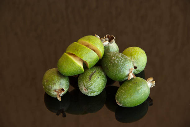 istock Fresh fruits of feijoa on a glass table with a reflection 1189740836