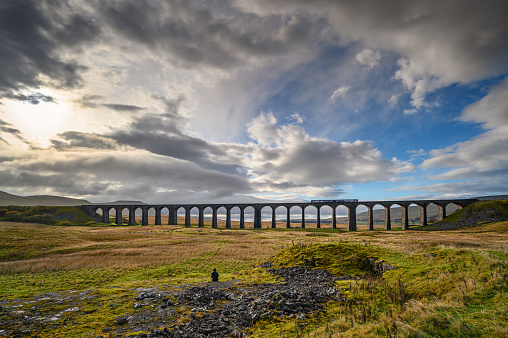 The Ribblehead Viaduct carries the Settle to Carlisle Railway across Batty Moss spanning 400 m and 32 m above the valley floor