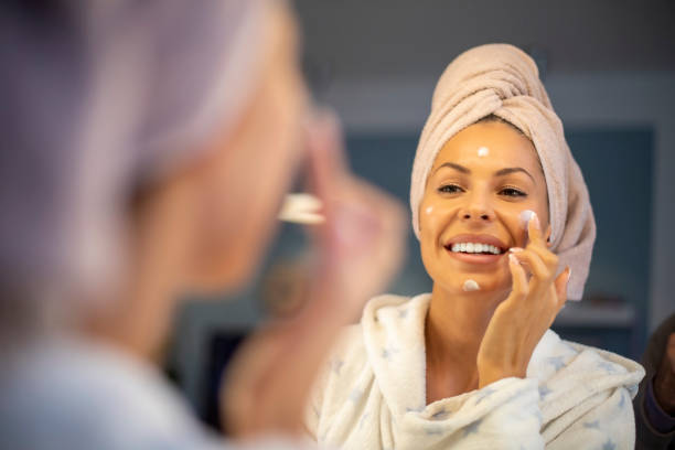 istock Young woman applying face cream. 1189744289