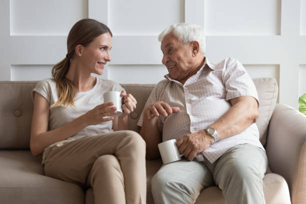 istock Happy young woman communicating with smiling old father. 1189748808