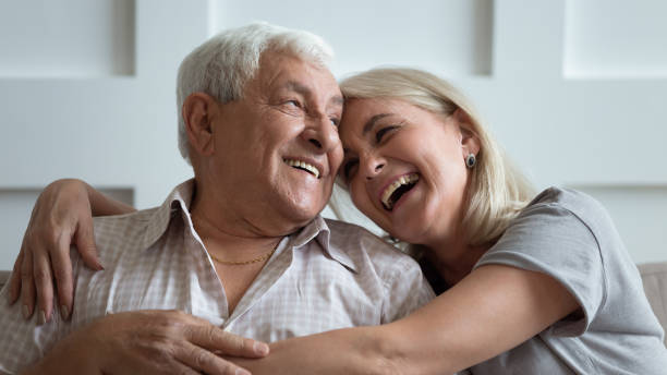 Overjoyed middle aged woman cuddling happy older 80s father. Close up head shot portrait overjoyed middle aged woman cuddling happy older grey haired 80s father at home. Laughing married family couple chatting, enjoying free weekend time together at home. father daughter 80s stock pictures, royalty-free photos & images