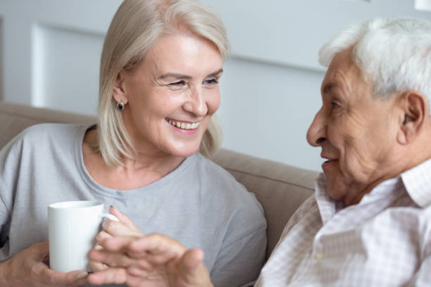 istock Happy middle aged grey haired woman talking with senior husband. 1189748823