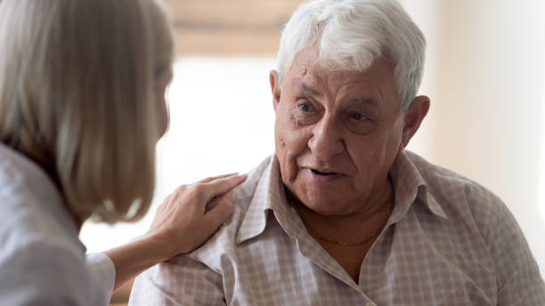 istock Pleasant older man thanking middle aged nurse for psychological help. 1189748868