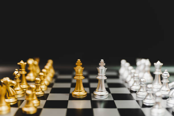 istock Business competition and strategy plan concept. Chess board game gold and silver colour 1189750813