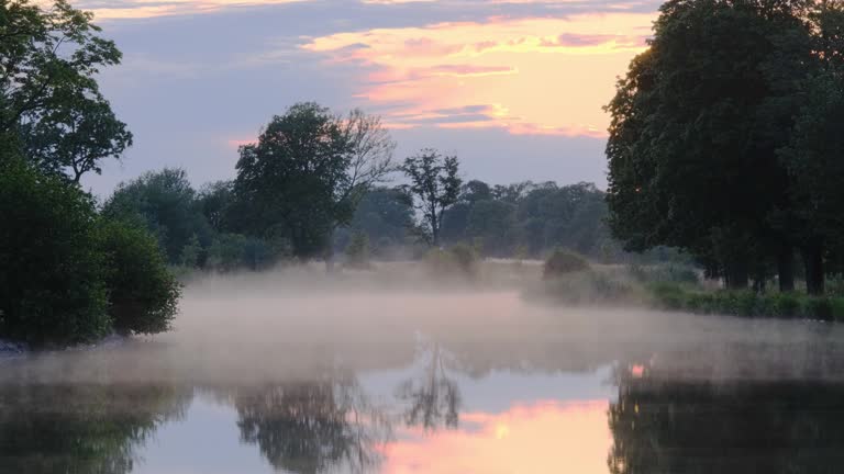 fog sweeping over the water with sunset in the background