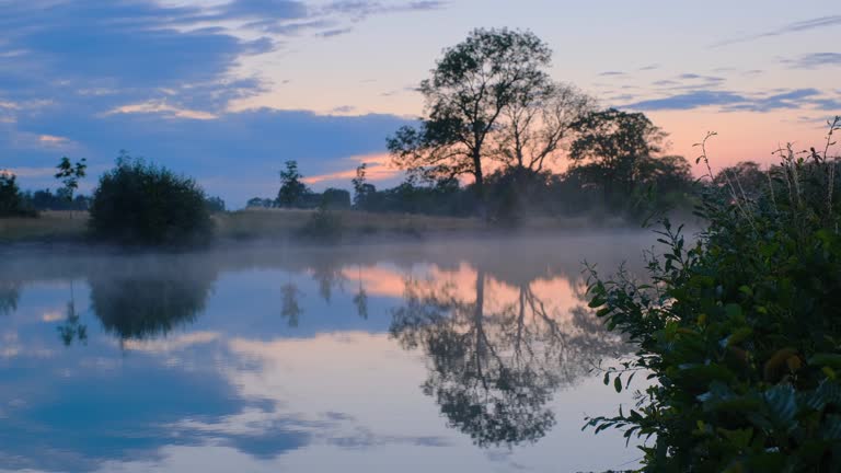 fog sweeping over the water with sunset in the background