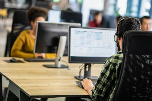 istock Call Center Employees Working In An Office 1189755400