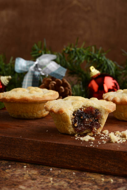 istock christmas mincemeat pie with bite on wood cutting board 1189756468