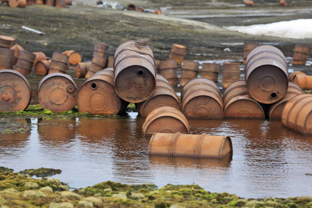 rusty drums on arctic coast - toxic waste toxic substance drum barrel imagens e fotografias de stock