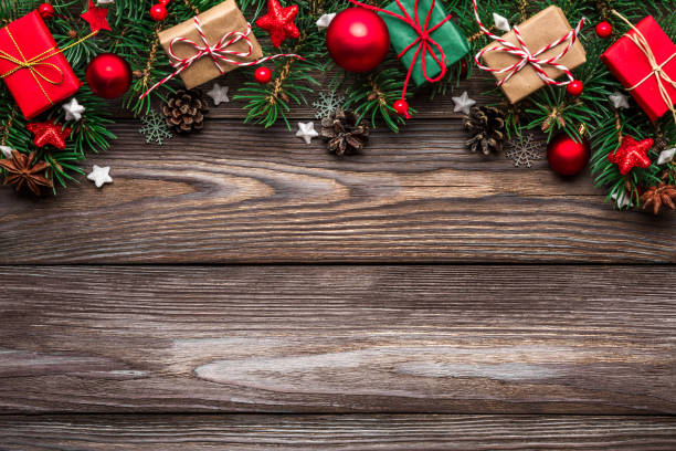 istock Christmas background with fir branches, decorations, gift boxes and pine cones on rustic wooden table. top view 1189756834