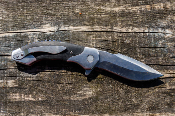 istock Folding knife on the rustic wooden background 1189756888