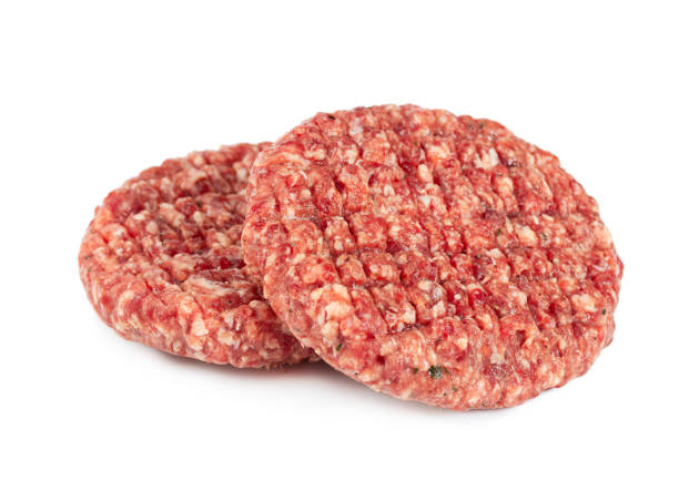istock Two raw burger meats isolated on white 1189756930