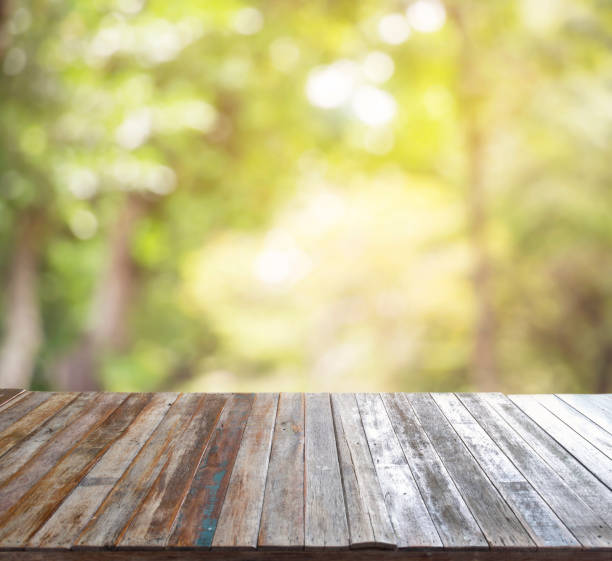 istock Empty wooden table template top on nature green blurred background for decorated montage of your product on table. 1189758083