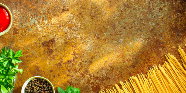 pasta raw, spaghetti or bucatini and tomato sauce ingredients. food background. copy space