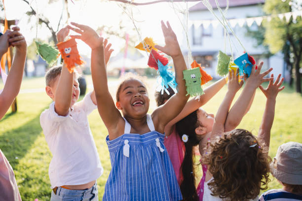 istock Small children standing outdoors in garden in summer, playing. 1189759593