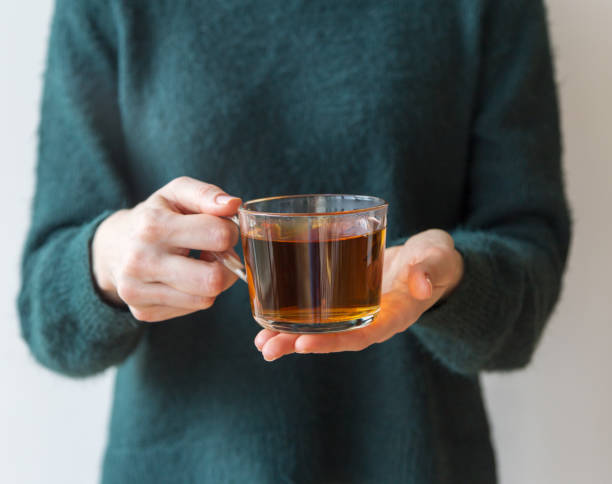 istock Tea glass cup in girls hand 1189760371