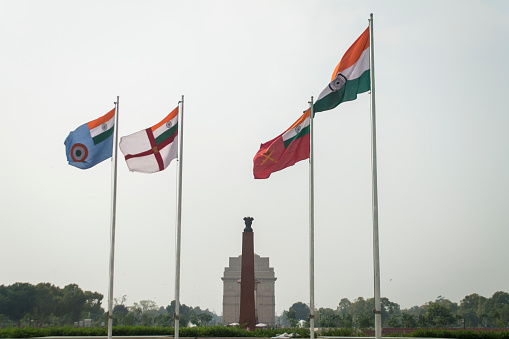 Delhi, India - September 30, 2019 : Indian National Flag with Army, Navy and Air force flags (right to left) at National War Memorial and India Gate.