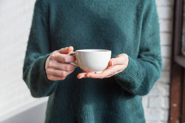 istock Tea cup in women's hand close up 1189760417