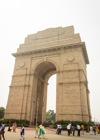 Delhi, India - September 30, 2019 : The India Gate, a war memorial standing on the Rajpath of New Delhi, with visitors around it.