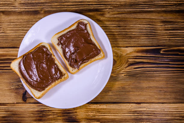 istock Two sandwiches with chocolate spread on a white plate. Top view 1189762932