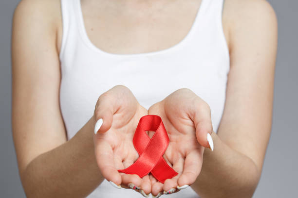 istock female hands holding red AIDS awareness ribbon 1189764127