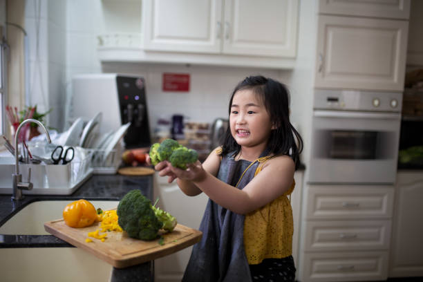 istock Girl is holding brocolli 1189764956
