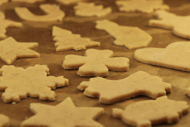 istock Cut out forms from raw dough. We see hearts, cars, trees and stars. Typical forms for christmas cookies. Christmas eve coming soon. Gift for Baby Jesus for gifts for us. Concept of happiness and famil 1189765367