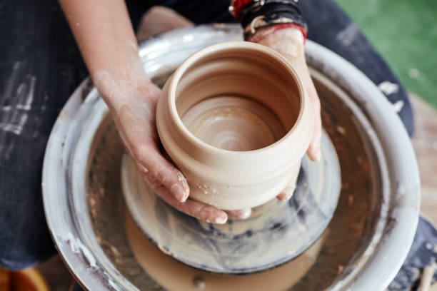 istock Woman's hands molding clay. Potter making ceramic pot in pottery workshop 1189766188