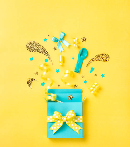 istock Blue surprise gift box  on a bright yellow background 1189767618