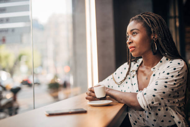 istock Young woman drinking coffee at the cafe 1189768350