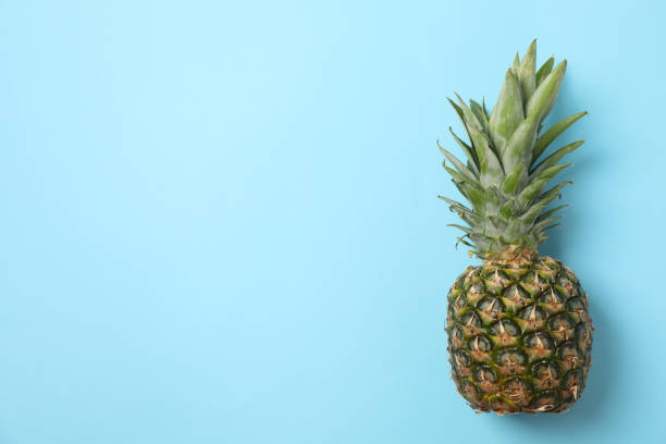 istock Pineapple on blue background, space for text. Juicy fruit 1189774136