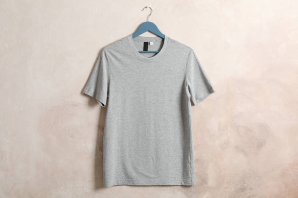 istock Hanger with blank gray t-shirt on brown background, space for text 1189776469