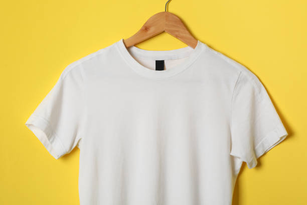 istock Hanger with blank white t-shirt on yellow background, space for text 1189776860