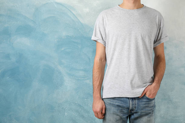 istock Men in blank grey t-shirt against blue background, space for text 1189777113