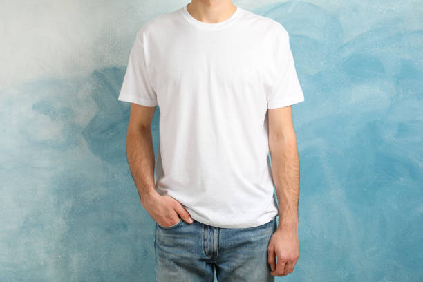 istock Men in blank white t-shirt against blue background, space for text 1189777151
