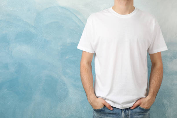 istock Men in blank white t-shirt against blue background, space for text 1189777360