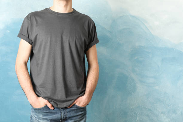 istock Men in blank grey t-shirt against blue background, space for text 1189777889