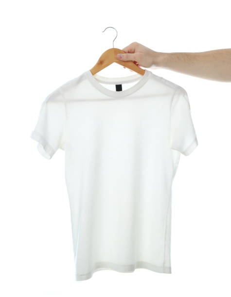 istock Man holds a hanger with blank t-shirt, isolated on white background 1189777965