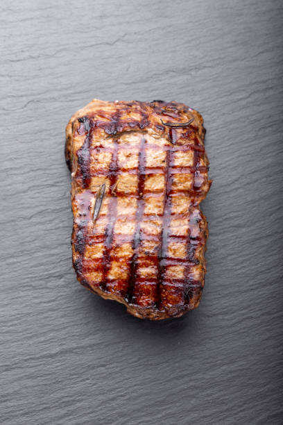 istock cooked on charcoal grill steak on a black background. 1189778069