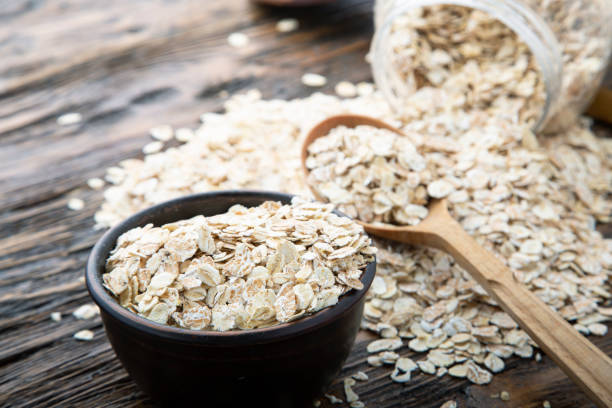 istock raw oatmeal in a spoon and in a plate on the table. 1189778186