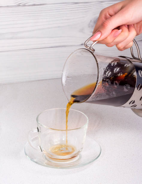 istock ready coffee brewed in an alternative way in a funnel v60 is poured into a Cup with a copy of the space 1189778437