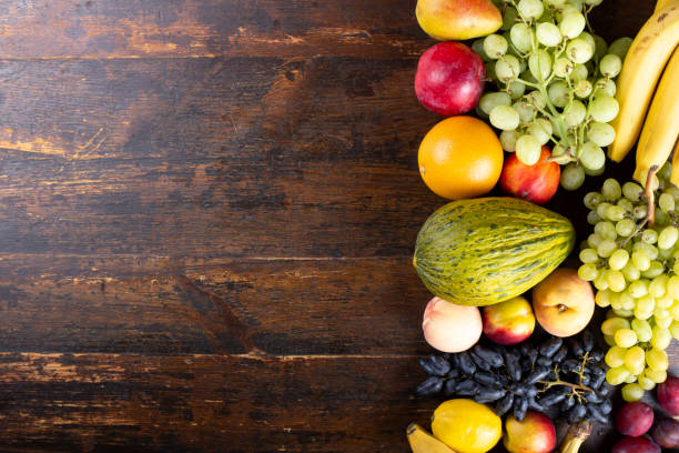 istock different fresh fruit set. on a wooden brown background. 1189778474