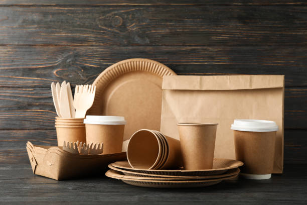 istock Eco - friendly tableware and paper bag on wooden table, copy space 1189780128