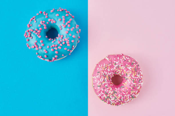 istock Two donuts on a pastel pink and blue background. Minimalism creative food composition. Flat lay style 1189781563