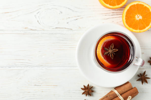 istock Mulled wine, orange and cinnamon on white wooden background, top view 1189783096