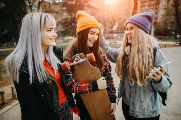 Photo of Cute female students in the campus park