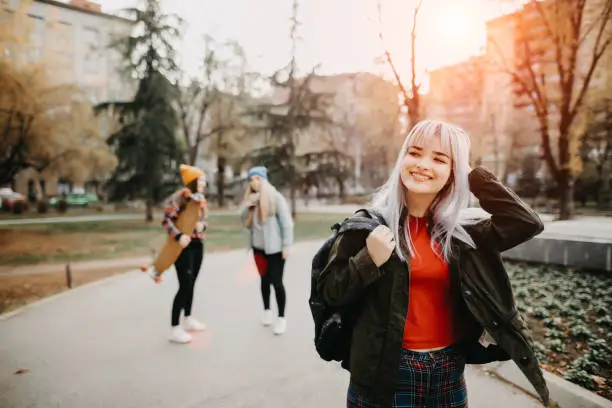 Photo of Cute female students in the campus park