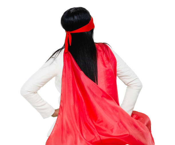 One person / waist up / portrait of 20-29 years old adult beautiful black hair / long hair latin american and hispanic ethnicity female / young women businesswoman / business person / superwoman / superhero / heroines wearing businesswear / business casual / smart casual / cape - garment / costume / eye mask / mask - disguise / a suit who is conquering adversity who is courage una persona / cintura para arriba / retrato de 20-29 años de edad adulto hermoso pelo negro / pelo largo latino y etnia hispana mujer / mujeres jóvenes empresaria / persona de negocios / supermujer / superhéroe / heroínas que llevan un traje que es cor