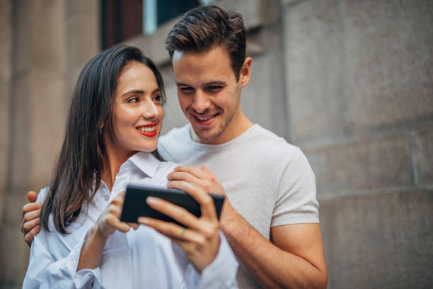 istock Couple standing outdoors and making selfie 1189792492