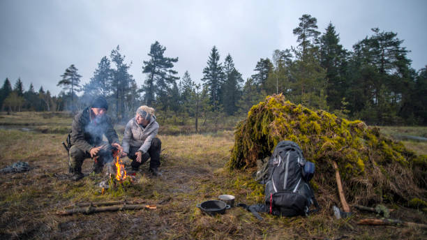 istock Couple camping on a forest meadow 1189793899